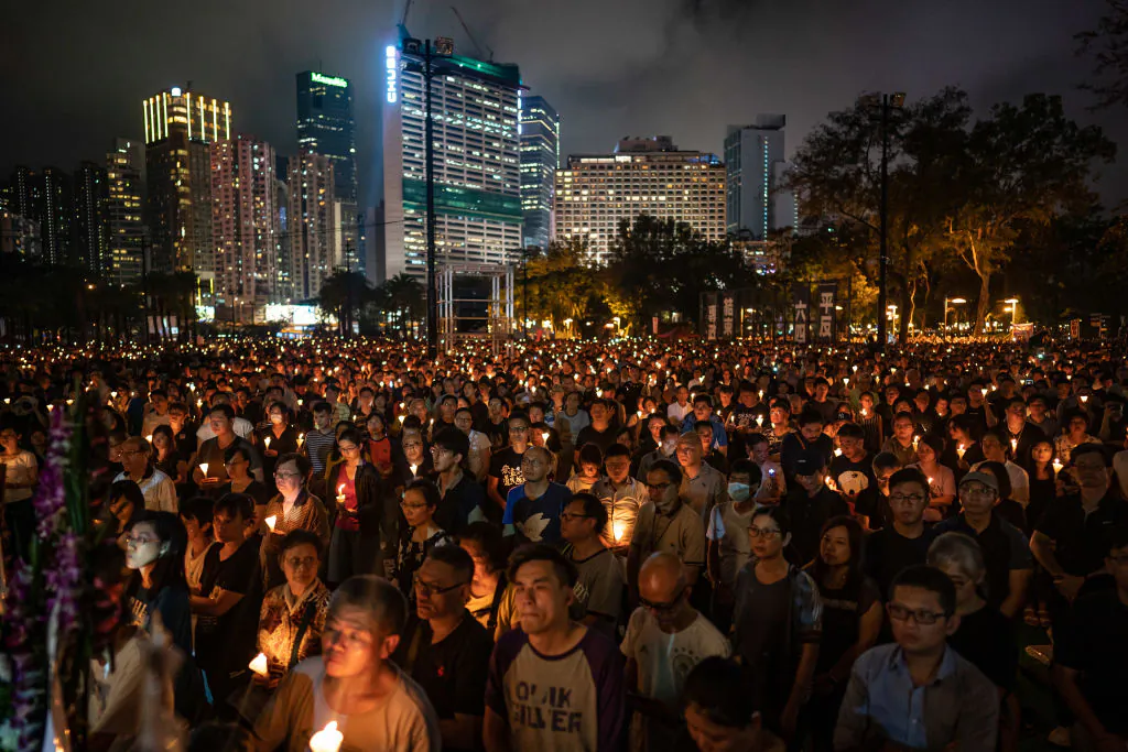 People hold candles as they take part in a candlelight vigil at Victoria Park in Hong Kong on June 4, 2019. (Anthony Kwan/Getty Images)