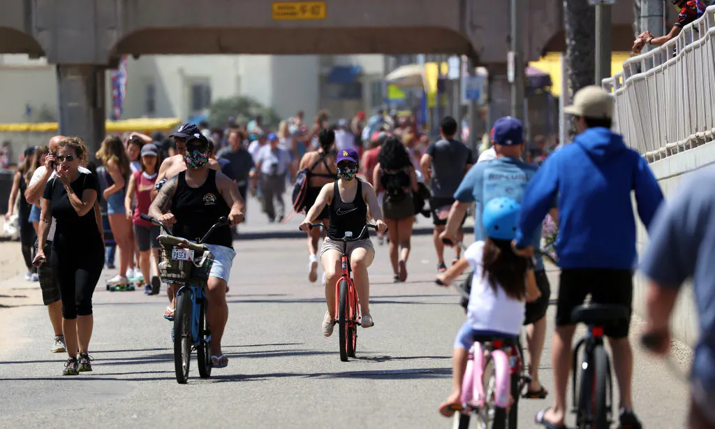 People ride and walk on a path in Huntington Beach, Calif., on May 15, 2020. Michael Heiman/Getty Images