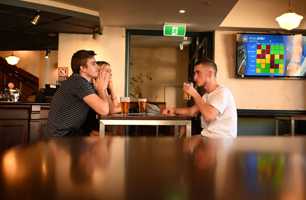 Patrons drink beer at a pub in the Rocks area of Sydney on June 1, 2020. (Peter Parks/AFP via Getty Images)