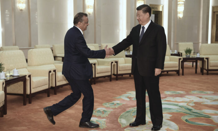 Tedros Adhanom (L), Director General of the World Health Organization, shakes hands with Chinese Leader Xi Jinping before a meeting at the Great Hall of the People in Beijing, China, on Jan. 28, 2020. (Naohiko Hatta - Pool/Getty Images)