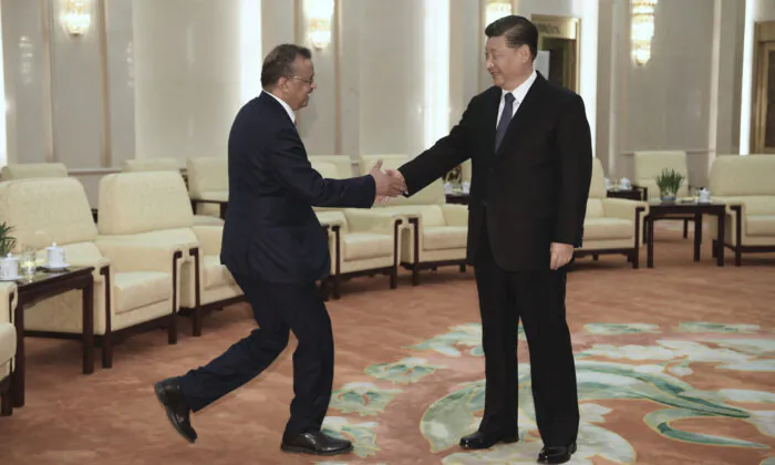 Tedros Adhanom (L), Director General of the World Health Organization, shakes hands with Chinese Leader Xi Jinping before a meeting at the Great Hall of the People in Beijing, on Jan. 28, 2020. (Naohiko Hatta/Pool/Getty Images)