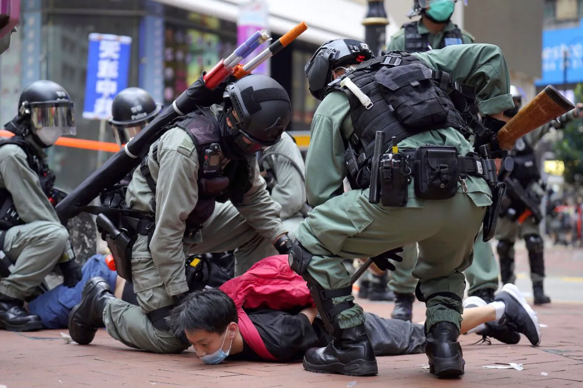 Riot police detain a protester during a demonstration against Beijing's national security legislation in Causeway Bay in Hong Kong on May 24, 2020. (Vincent Yu/AP Photo)