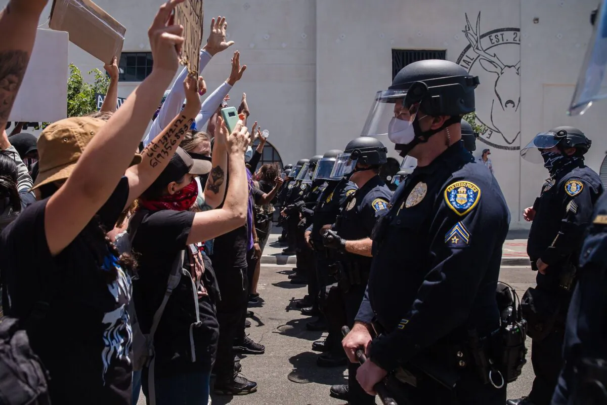 Demonstrators face-off with officers in front of the San Diego Police Department in downtown San Diego, Calif., on May 31, 2020 (Ariana Drehsler/AFP via Getty Images)