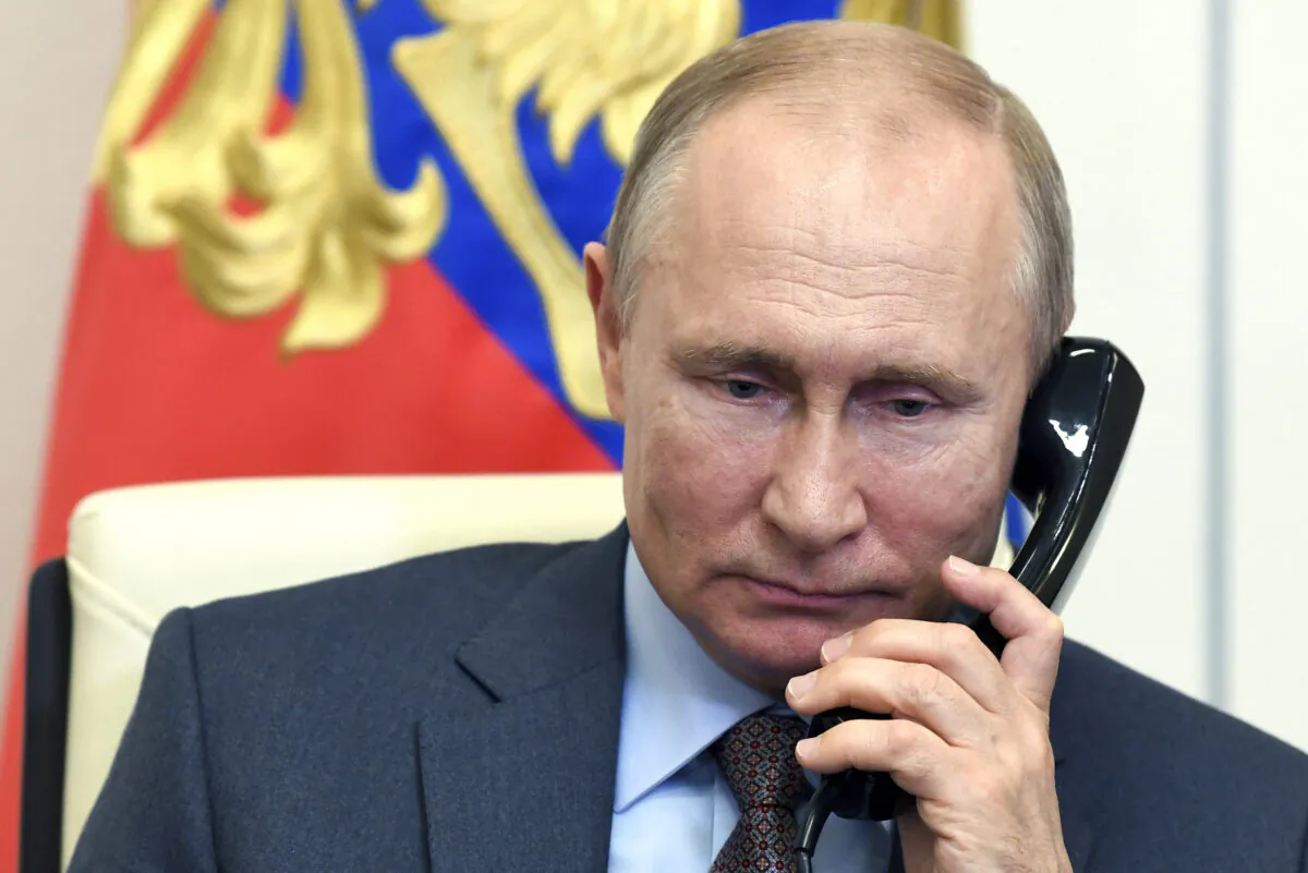 Russian President Vladimir Putin speaks on the phone during a meeting with Russian Prime Minister Mikhail Mishustin via teleconference at the Novo-Ogaryovo residence outside Moscow on June 2, 2020. (Alexei Nikolsky, Sputnik, Kremlin Pool Photo via AP)