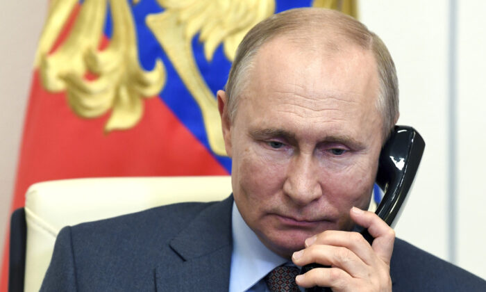 Russian President Vladimir Putin speaks on the phone during a meeting with Russian Prime Minister Mikhail Mishustin via teleconference at the Novo-Ogaryovo residence outside Moscow on June 2, 2020. (Alexei Nikolsky, Sputnik, Kremlin Pool Photo via AP)
