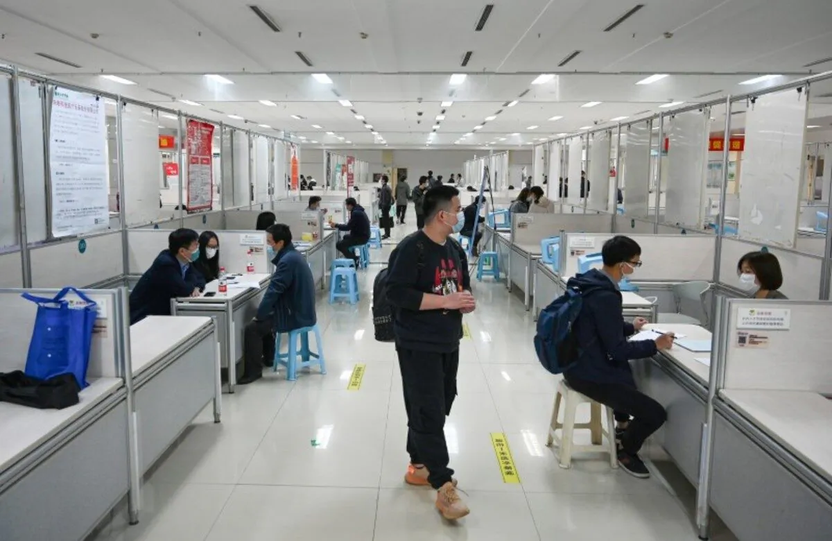 People wearing face masks to prevent the spread of the CCP virus attend a job fair in Hangzhou, Zhejiang province, China, on April 14, 2020. (cnsphoto via Reuters)