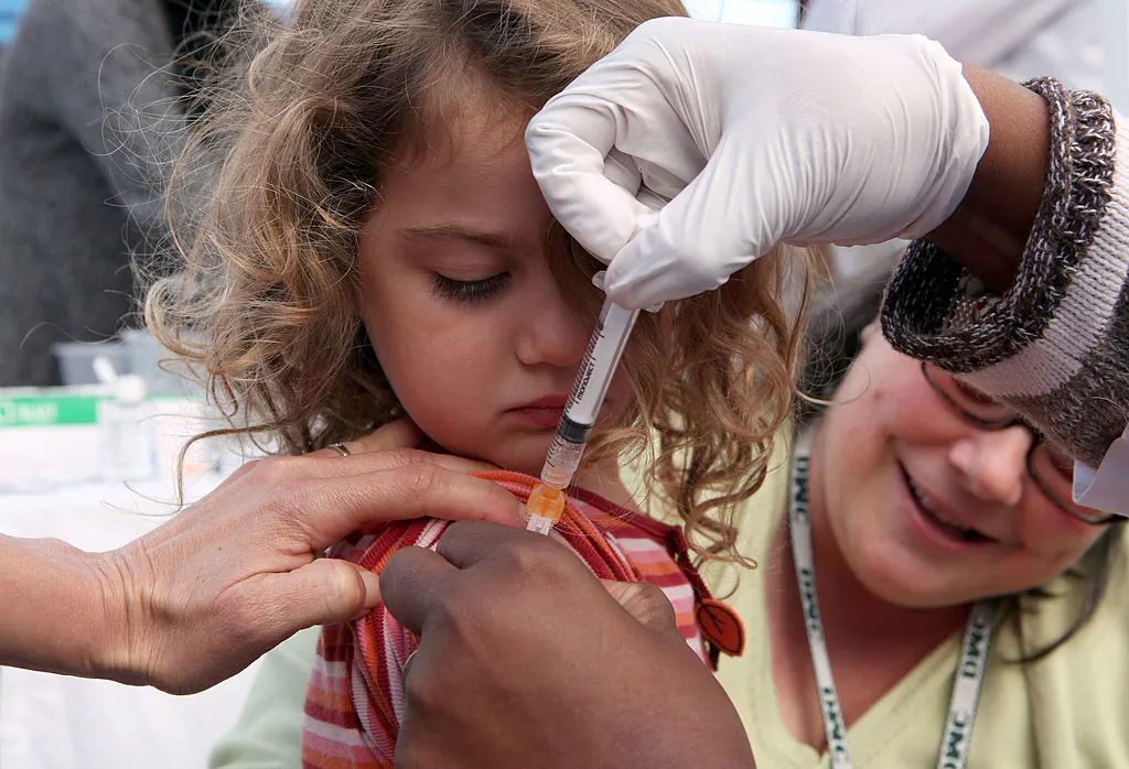 Three-year-old Hannah Rood receives an H1N1 vaccination at a drive-thru H1N1 vaccination clinic at Doctor’s Medical Center in San Pablo, Calif., on Nov. 5, 2009. (Photo by Justin Sullivan/Getty Images)