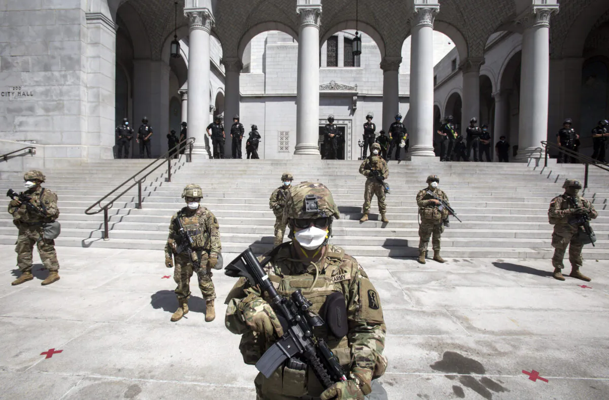 Members of California National Guard stand guard outside City Hall in Los Angeles, in a file photo. (Ringo H.W. Chiu/AP Photo)