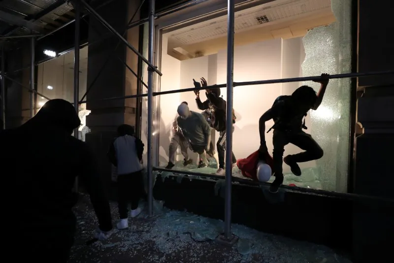 A man jumps from the window of a damaged store in New York City, N.Y., June 2, 2020. (Jeenah Moon/Reuters)