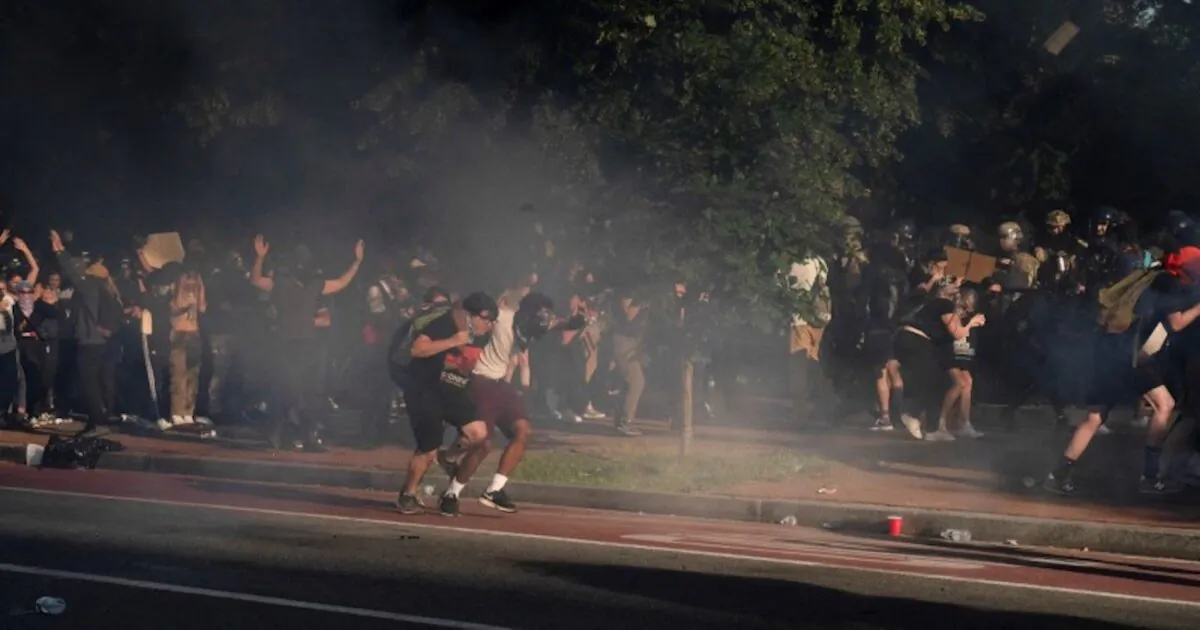 Protestors run as riot police fire crowd control devices and move on demonstrators to clear Lafayette Park and the area around it across from the White House in Washington D.C. on June 1, 2020. (Ken Cedeno/Reuters)