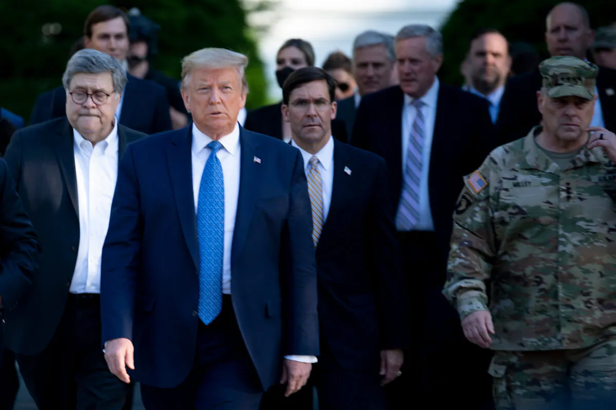 President Donald Trump walks with Attorney General William Barr, left, Secretary of Defense Mark Esper, center, Chairman of the Joint Chiefs of Staff Mark Milley, right, and others from the White House to visit St. John's Church on June 1, 2020. (Brendan Smialowski/AFP via Getty Images)