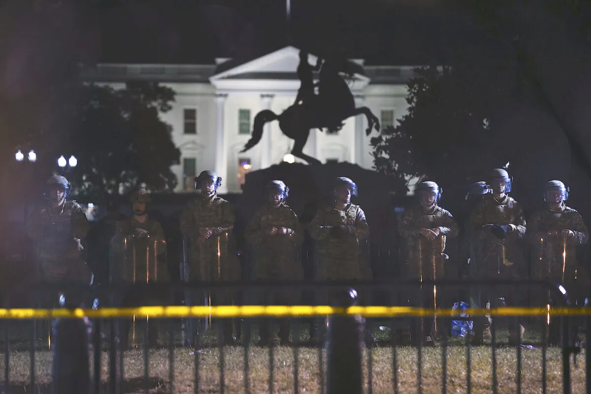 With the White House in the background, a line of police forms behind a fence in Lafayette Park as demonstrators gather in Washington on June 2, 2020. (Evan Vucci/AP Photo)