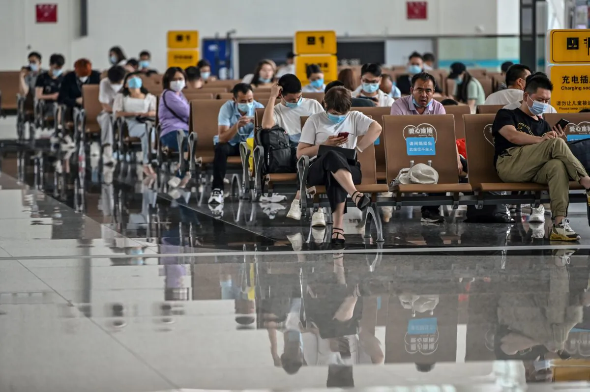 Passengers wearing protective masks sit as they wait for their flights at Tianhe Airport in Wuhan, in Chinas central Hubei province, on May 29, 2020. (Hector Retamal /AFP via Getty Images)