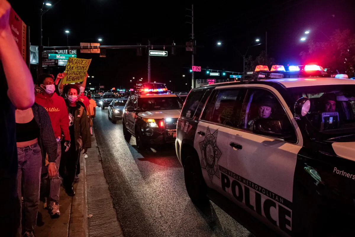 Police officers look at protesters during a Black Lives Matter protest in Las Vegas, Nev., on June 1, 2020. (Bridget Bennett/AFP via Getty Images)