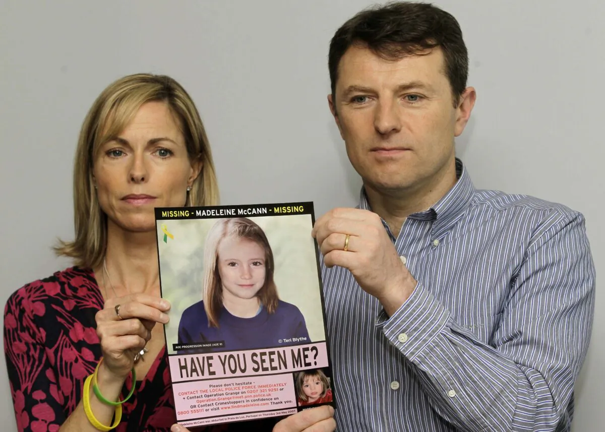 Kate and Gerry McCann pose for the media with a missing poster depicting an age progression computer generated image of their still missing daughter Madeleine during a news conference in London on May 2, 2012. (Sang Tan/AP Photo)