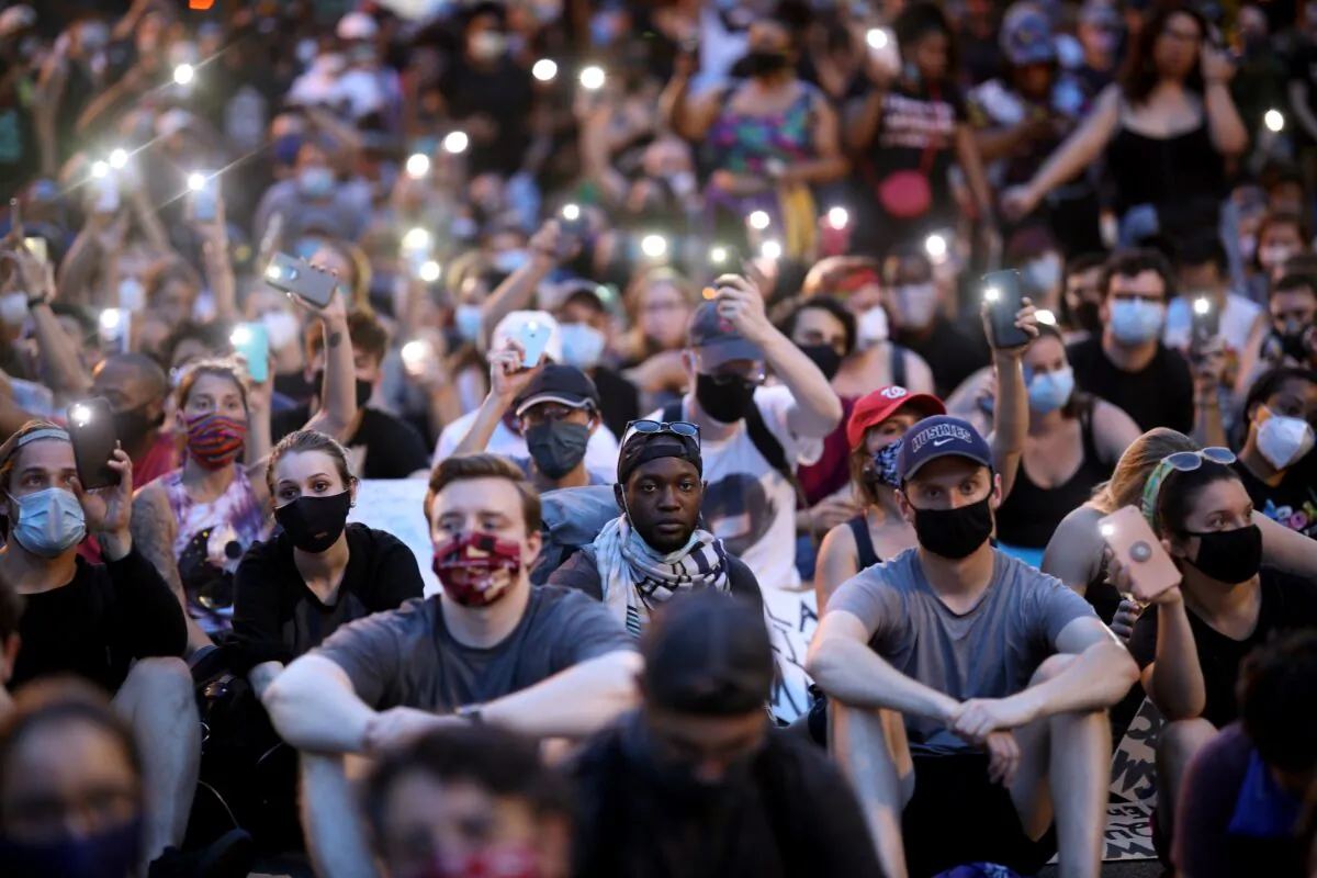 Demonstrators sing "Lean On Me" during a protest near the White House White House in Washington on June 3, 2020. (Win McNamee/Getty Images)