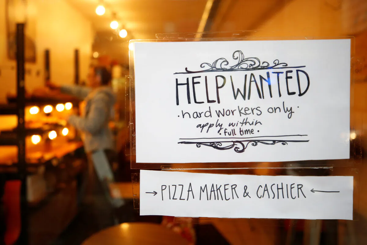 A "help wanted" sign is seen in the window of a bakery in Ottawa, in this file photo. (Chris Wattie/Reuters)