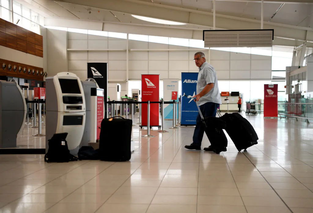 Passengers check in for a Qantas flight at Adelaide Airport on April 01, 2020 in Adelaide, Australia. (Tracey Nearmy/Getty Images)