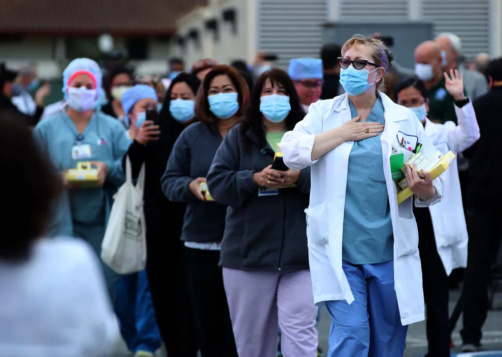 Nurses are applauded by police and firefighters as they leave Kaiser Hospital at the end of their shift in South San Francisco, California on May 14, 2020. (Justin Sullivan/Getty Images)