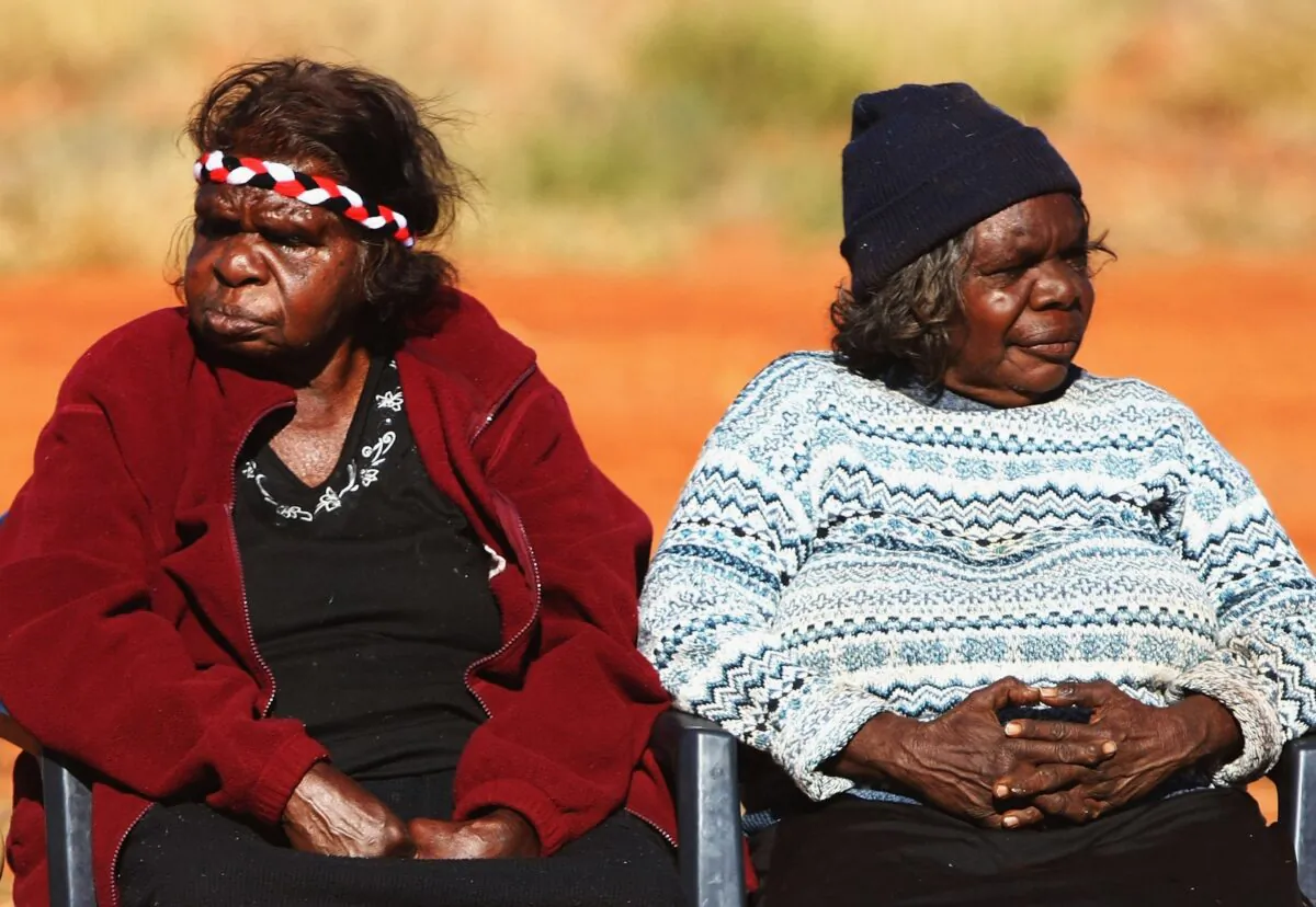 Aboriginal women gather to meet Indigenous Affairs Minister Mal Brough as he arrives for a meeting with the Mutitjulu community in Mutitjulu, near Alice Springs, Australia, on July 6, 2007. (Ian Waldie/Getty Images)