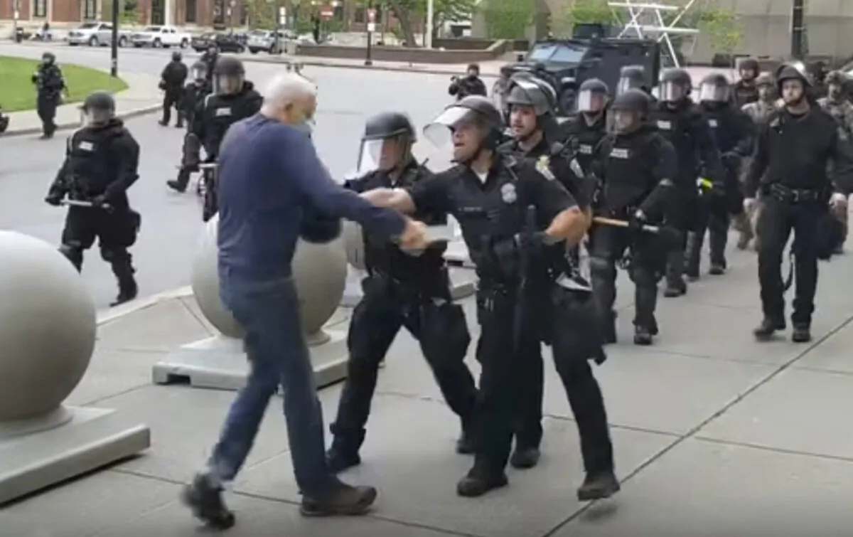 A Buffalo police officer appears to shove a man who walked up to police, in Buffalo, N.Y., on June 4, 2020. (Mike Desmond/WBFO via AP)