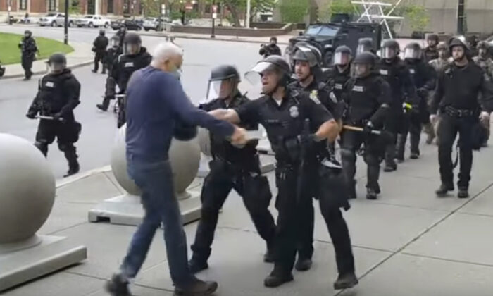A Buffalo police officer appears to shove a man who walked up to police, in Buffalo, N.Y., on June 4, 2020. (Mike Desmond/WBFO via AP)