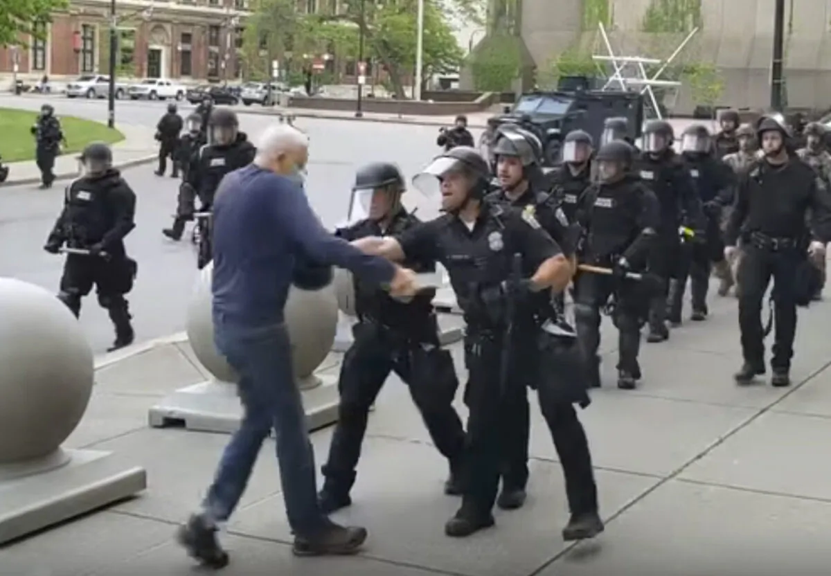 A Buffalo police officer appears to shove a man who walked up to police, in Buffalo, N.Y., on June 4, 2020. (Mike Desmond/WBFO via AP)