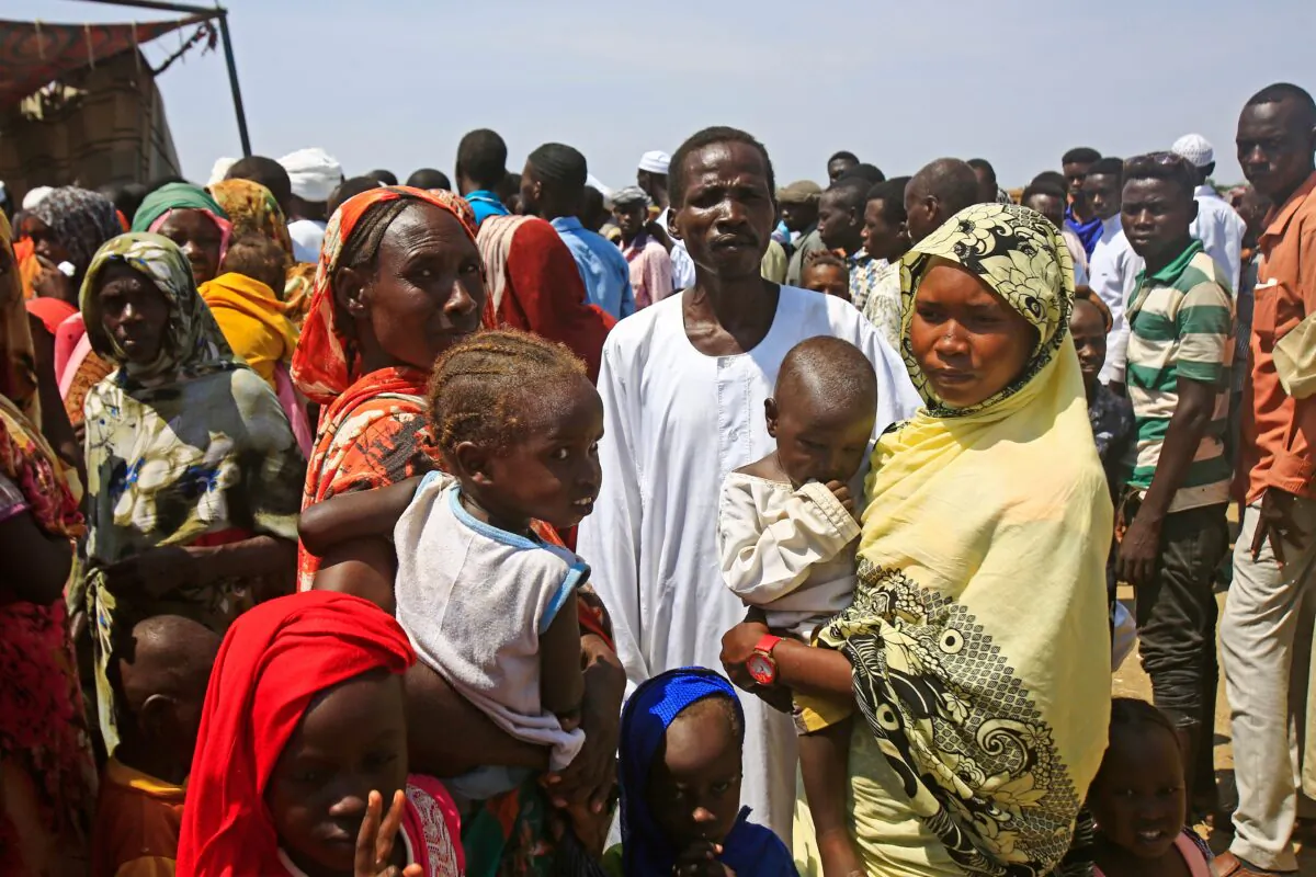 Displaced Sudanese queue to receive humanitarian aid supplies at the Kalma camp for internally displaced people in Darfur's state capital Niyala on Oct. 9, 2019. (Ashraf Shazly/AFP via Getty Images)