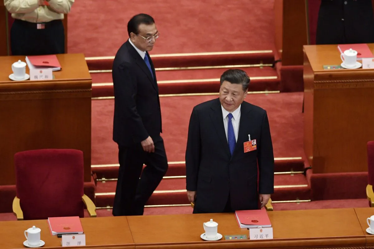 Chinese leader Xi Jinping and Premier Li Keqiang arrive for the closing session of the rubber stamp legislative meeting at the Great Hall of the People in Beijing on May 28, 2020. (NICOLAS ASFOURI/AFP via Getty Images)