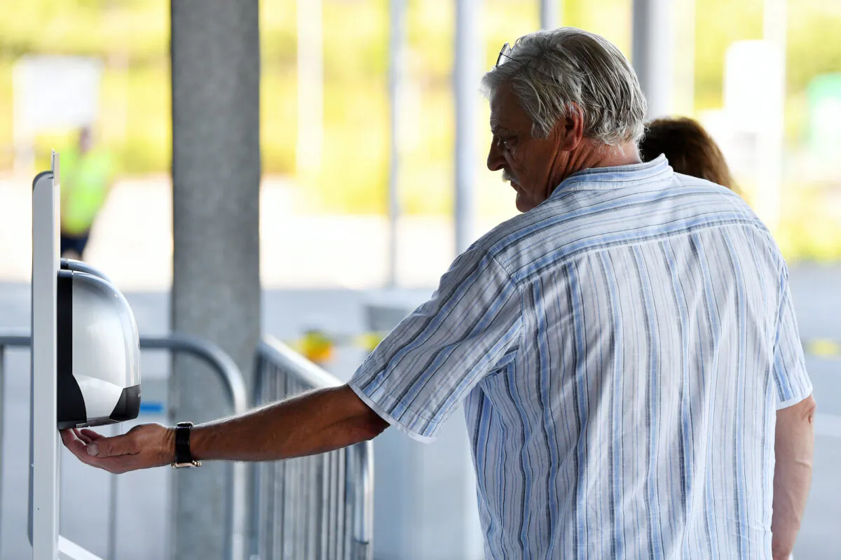 A customer uses hand sanitizer before entering the store in Exeter, UK, on June 1, 2020. (Dan Mullan/Getty Images)
