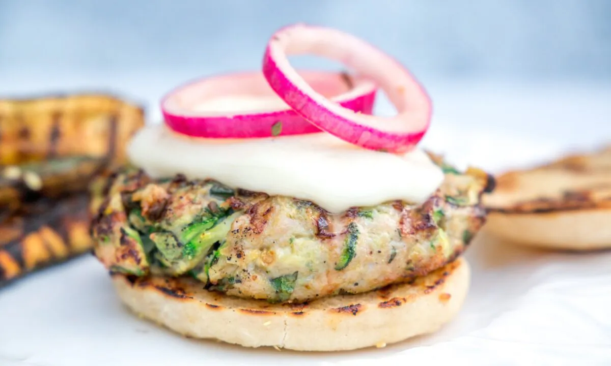 Juicy chicken patties, melty mozzarella, and tangy quick-pickled onions make for a perfect summertime meal by the grill. (Caroline Chambers)