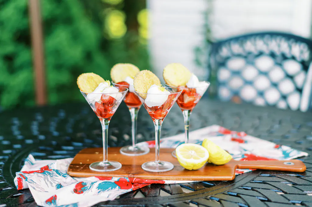 Strawberries and lemon whipped cream in martini glasses, topped with a mini-biscuit, are a fun take on classic strawberry shortcake. (Matt Genders)