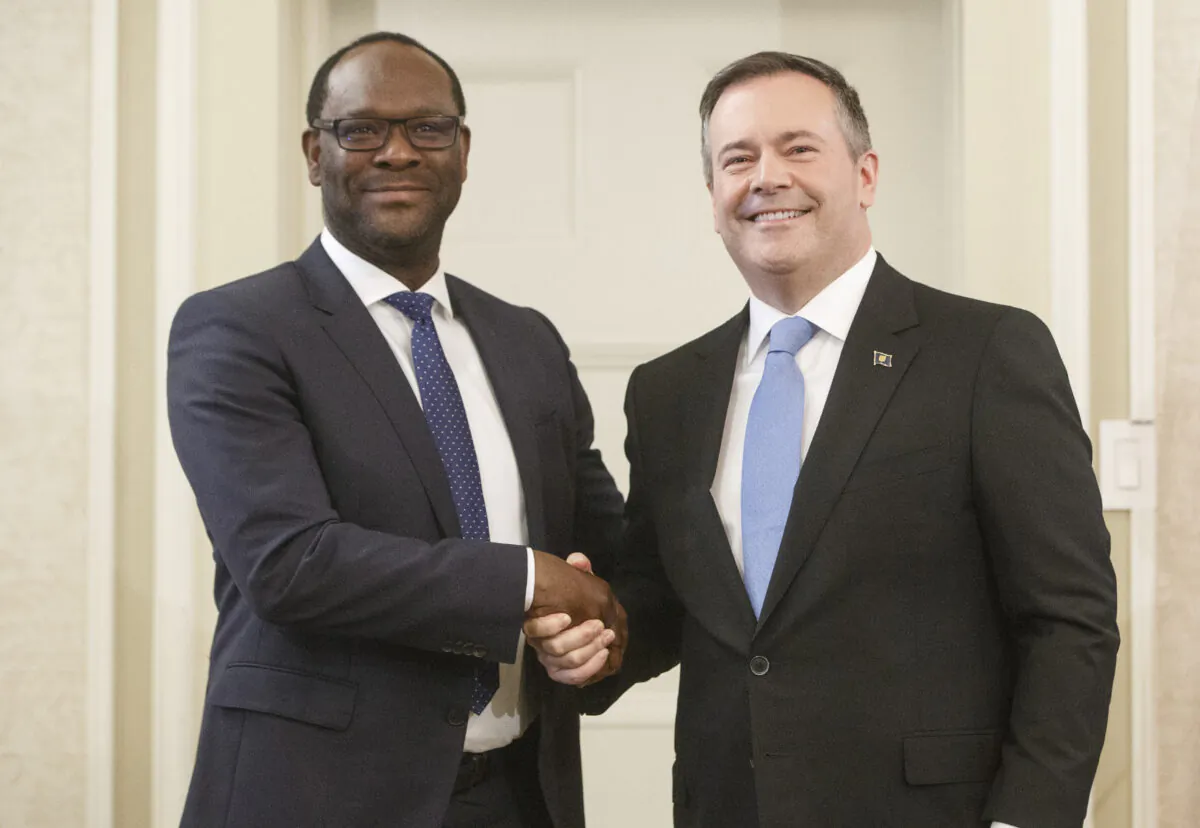 Alberta premier Jason Kenney shakes hands with Kaycee Madu, Minister of Municipal Affairs after being sworn into office in Edmonton on April 30, 2019. (Jason Franson/The Canadian Press)