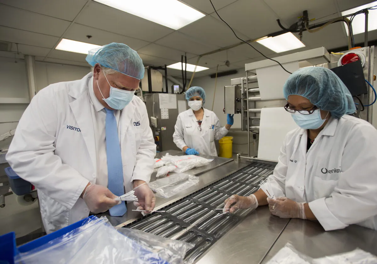 Ontario Premier Doug Ford visits Canadian Hospital Specialities (CHS) helping them take dual COVID-19 testing swab kits and separating them into two units to help with swab capacity during the COVID-19 pandemic in Oakville, Ont., on June 8, 2020. (Nathan Denette/The Canadian Press)