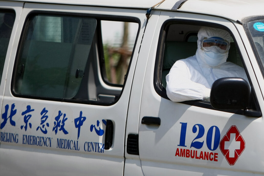 A hospital worker sits in an ambulance in Beijing's Ditan hospital in Beijing on May 17, 2009. (Feng Li/Getty Images)