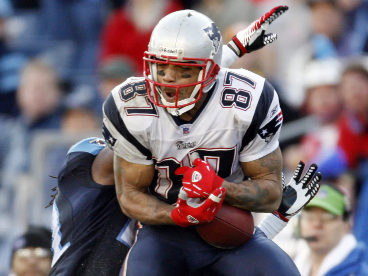 New England Patriots wide receiver Reche Caldwell (87) catches a pass for a 62-yard touchdown ahead of Tennessee Titans cornerback Reynaldo Hill in the third quarter of an NFL football game in Nashville, Tenn., on Dec. 31, 2006. (John Russell/File/AP Photo)