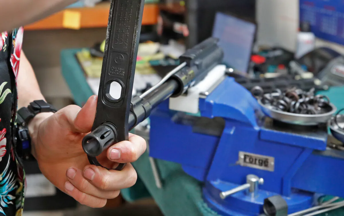 A worker assembles an AR-15 rifle at Delta Team Tactical in Orem, Utah, on March 20, 2020. (George Frey/AFP via Getty Images)