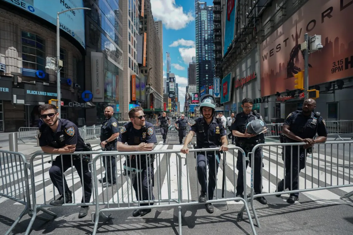 Members of the New York City Police Department look on as protesters demonstrate in Times Square on June 7, 2020, following the death of George Floyd by a Minneapolis police officer in New York. (Bryan R. Smith/AFP via Getty Images)