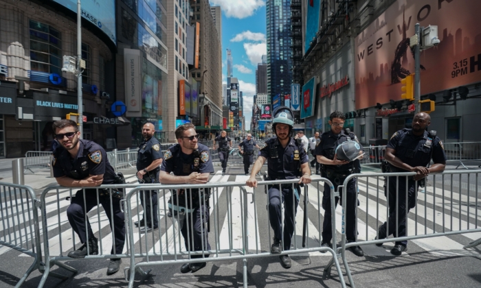 Members of the New York City Police Department look on as protesters demonstrate in Times Square on June 7, 2020, following the death of George Floyd by a Minneapolis police officer in New York. (Bryan R. Smith/AFP via Getty Images)