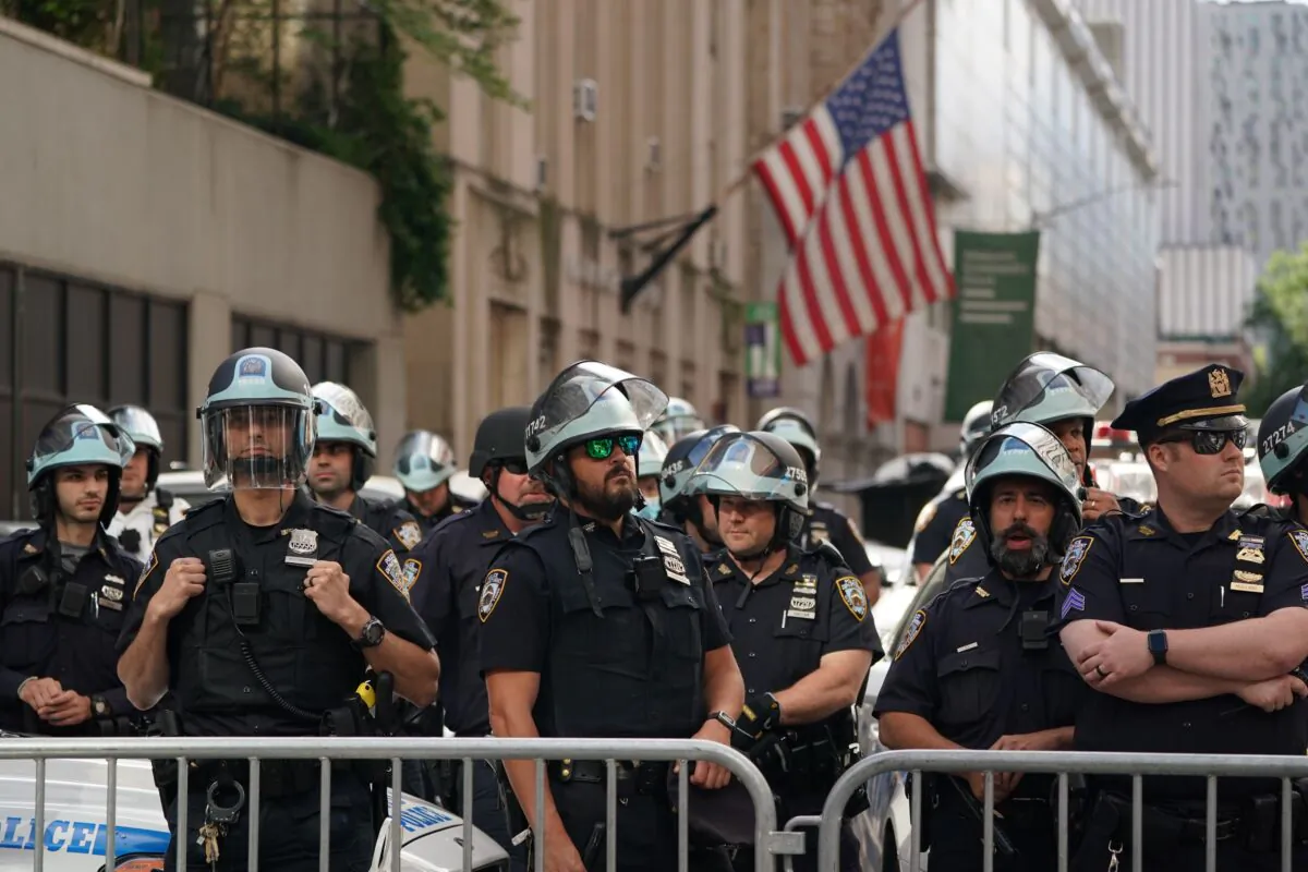 Members of the New York City Police Department look on from the Midtown North Precinct as Black Lives Matter protesters march in midtown over the death of George Floyd by a Minneapolis police officer on June 7, 2020. (Bryan R. Smith/AFP via Getty Images)
