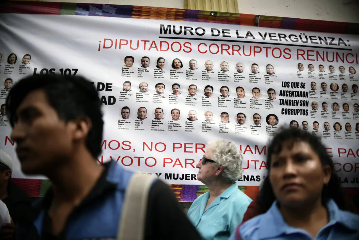 A banner depicting portraits of national deputies accused of corruption is displayed during a protest demanding the resignation of Guatemalan President Jimmy Morales, in Guatemala City on Nov. 16, 2017. (Johan Ordonez/AFP/Getty Images)