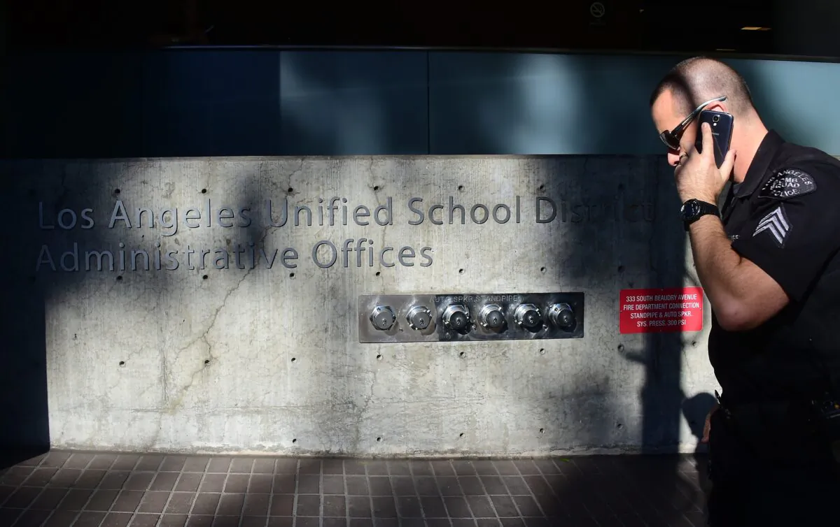 A police officer walks past the administrative offices of the Los Angeles Unified School District, in Los Angeles, Cali., on December 15, 2015. (Frederic J. Brown/Getty Images)