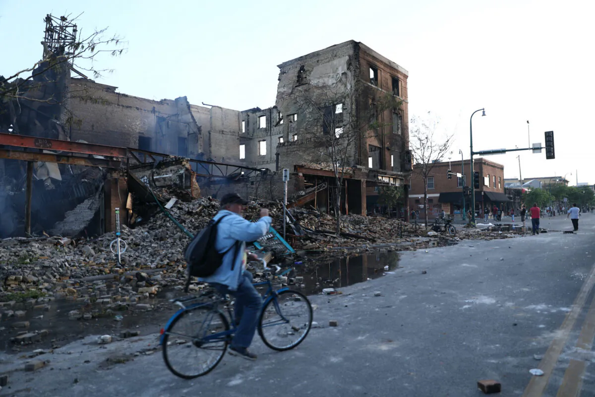 A destroyed building smolders near the Minneapolis Police 3rd Precinct the day after it was attacked and burned by rioters following the death of George Floyd, in Minneapolis, Minn., on May 29, 2020. (Charlotte Cuthbertson/The Epoch Times)