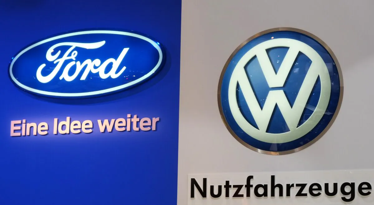 The logos of car makers Ford (L) and Volkswagen (VW, R) are seen at the expo "Caravan Salon Duesseldorf" at the fair grounds in Duesseldorf, western Germany, on Aug. 31, 2014. (Patrik Stollarz/AFP via Getty Images)