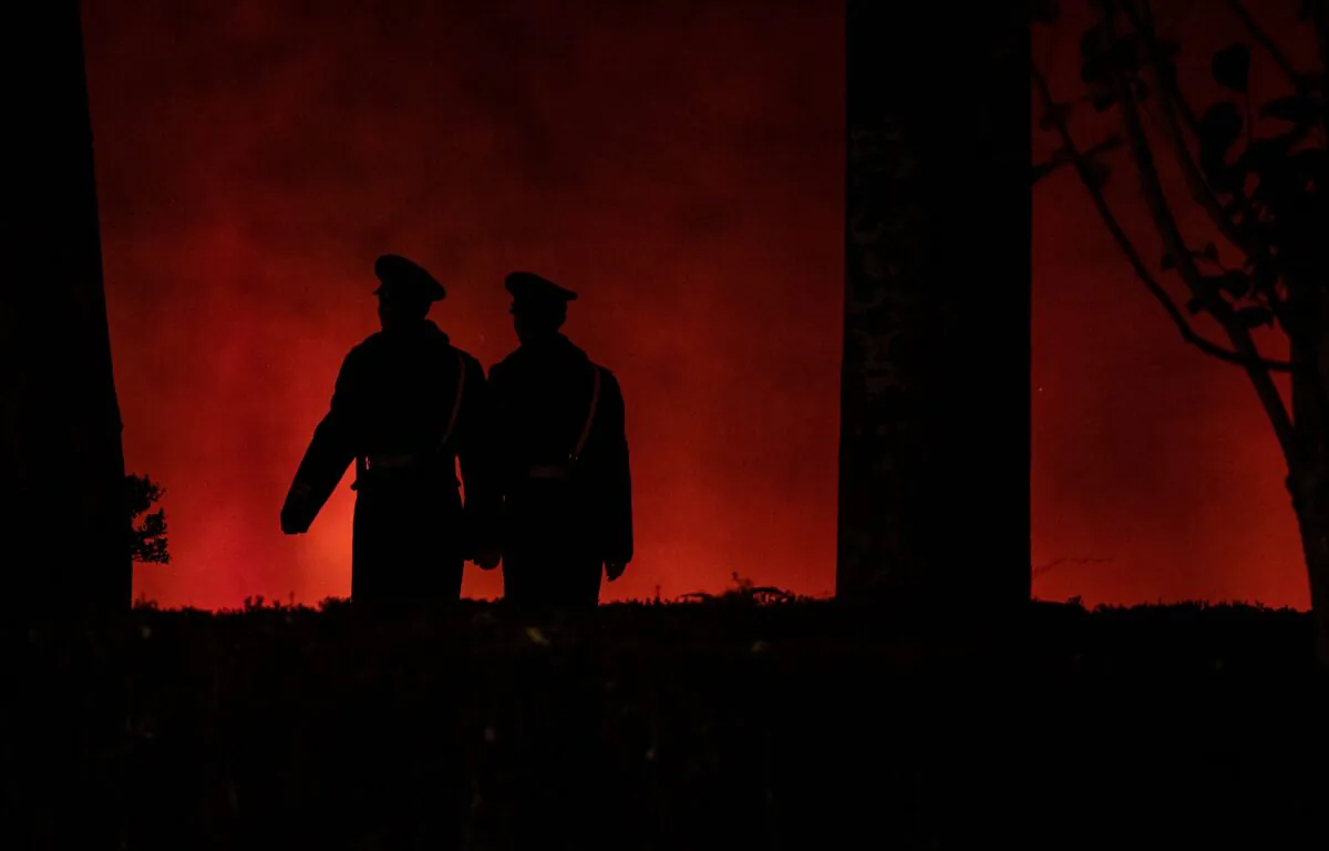 Paramilitary policemen walk along a red wall near the Tiananmen Gate in Beijing on Nov. 13, 2019. (Noel Celis/AFP via Getty Images)