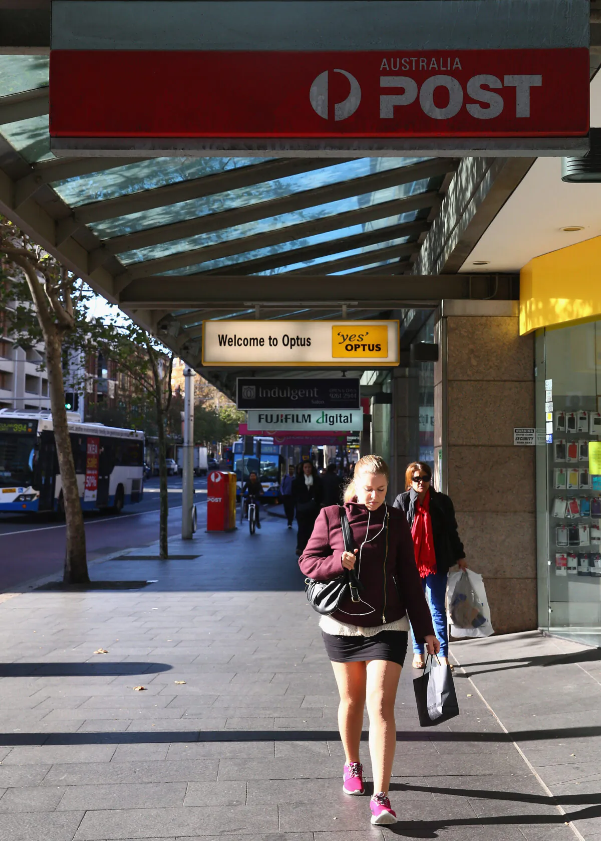 People walk down Oxford street underneath a Darlinghurst post office sign on May 7, 2014 in Sydney, Australia.(Don Arnold/Getty Images)