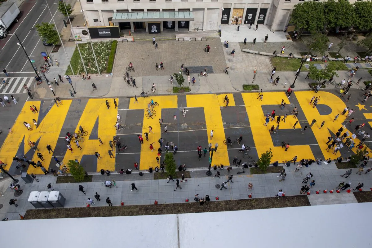 People walk down 16th street after Mayor Muriel Bowser had "Black Lives Matter" painted on the street near the White House on June 5, 2020. (Tasos Katopodis/Getty Images)