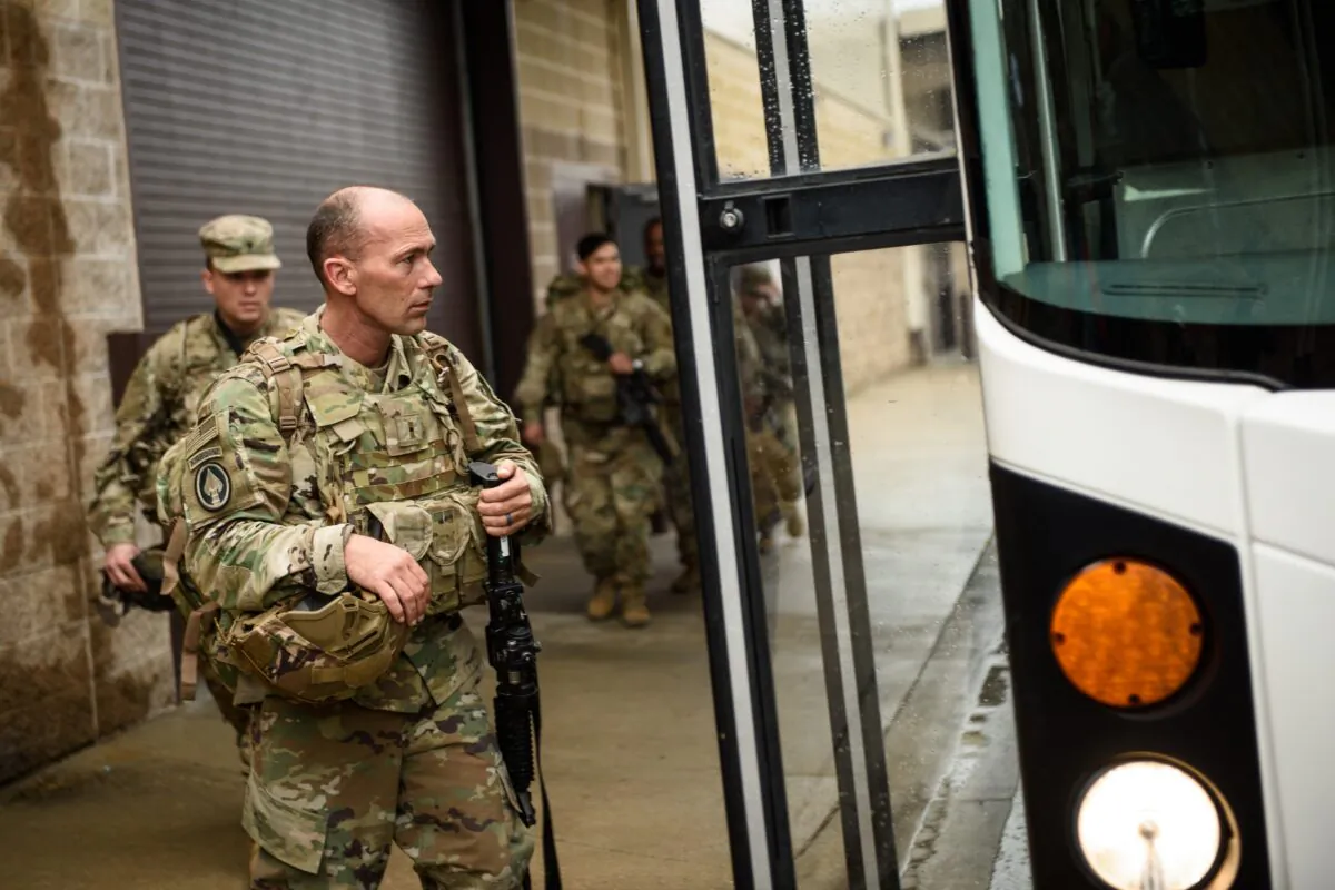 U.S. troops from the Army's 82nd Airborne Division board a bus as they head out for a deployment to the Middle East in Fort Bragg, N.C., on Jan. 4, 2020. (Andrew Craft/Getty Images)