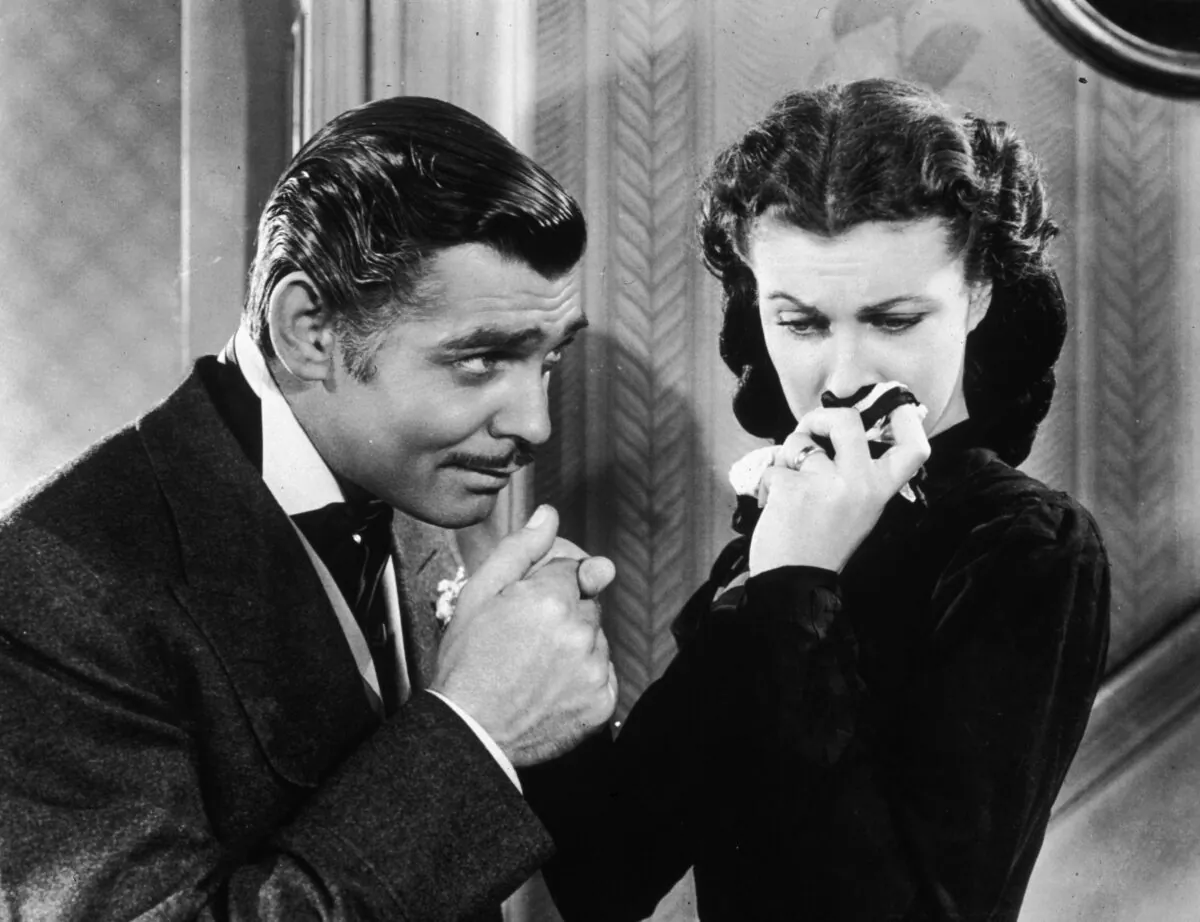 Actor Clark Gable in his role as Rhett Butler kissing the hand of a tearful Scarlett O'Hara, played by Vivien Leigh, in 'Gone With the Wind.' (Hulton Archive/Getty Images)