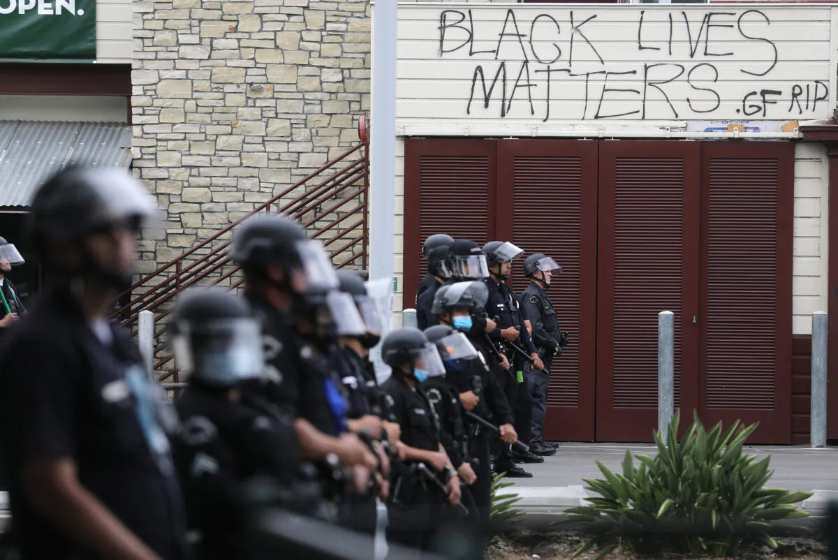 LAPD officers keep watch during demonstrations following the death of George Floyd, in Los Angeles, Calif., on May 30, 2020. (Mario Tama/Getty Images)